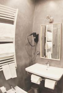 a bathroom with a sink and a mirror at WE LOVE ROMA Guest House in Rome