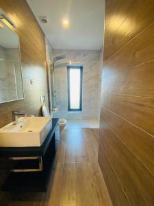 a bathroom with a sink and a toilet and a window at Dobau casas in Vieira do Minho