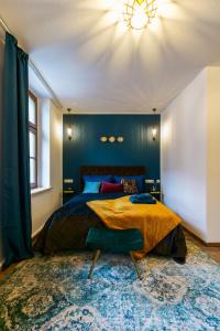 a bedroom with a bed and a blue wall at Kerkermeister Pension in Auerbach
