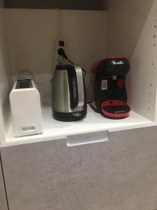 a shelf with a toaster and a blender on it at Appartement Fontargente in Ax-les-Thermes