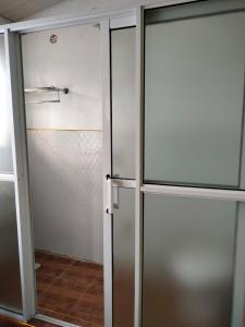 two sliding glass doors in a room with at Bloom 2 private home in Thika