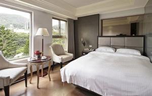 Letto o letti in una camera di JBG Hotspring Resort Hotel