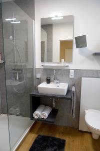 ein Bad mit einem Waschbecken und einer Dusche in der Unterkunft Ferienwohnung Wagner 4 Sterne in Neef