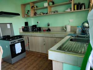 a kitchen with a sink and a stove at Bloom 2 private home in Thika