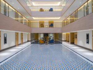 an empty hallway with a pool in the middle of a building at IKON By Annapoorna in Coimbatore