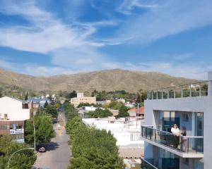 a view of a city from a balcony of a building at Terra Departamentos Boutique in La Falda