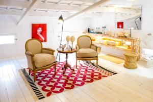 a living room with two chairs and a table at Ca na Kika 5 in Es Migjorn Gran