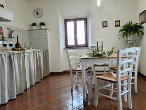 a kitchen with a table and chairs in a room at Cortona's Rooftop Nest in Cortona