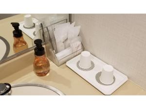 a bathroom counter with a mirror and a sink at Onomichi Kokusai Hotel - Vacation STAY 87045v in Onomichi