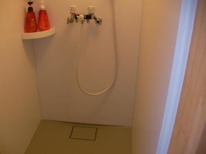 a bathroom with a shower with a hose on the wall at Gujo Cottage Ryukobashi no Hotori - Vacation STAY 88697v in Gujo