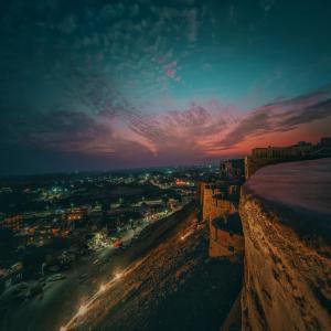 a view of a city at night at Mud Mirror Guesthouse in Jaisalmer