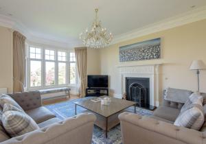 a living room with two couches and a fireplace at St Aidans in North Berwick