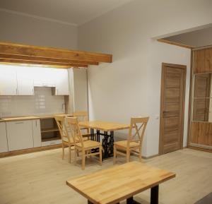 a kitchen and dining room with a table and chairs at ART Apartment in Mukacheve