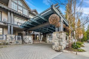 a building with a walkway in front of it at Modern Studio at Blackcomb base in Whistler