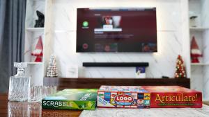 a table with two boxes of snacks and a television at Oceanview Smart Home with Pool in Oniru-Lekki 1 in Lekki