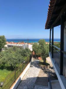 a balcony of a house with a view of the ocean at Vila Vergina in Pefkochori