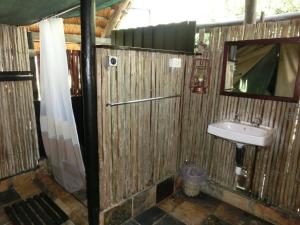 a bathroom with a sink and a mirror at KwaMbili Game Lodge in Thornybush Game Reserve