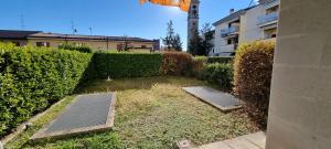 a garden with two solar panels in front of a hedge at Casa la Vigna in Bergamo