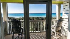 a balcony with chairs and a view of the ocean at WaterColor Inn & Resort in Santa Rosa Beach