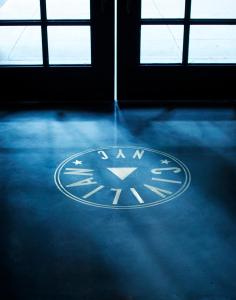 a clock in the middle of a room with windows at CIVILIAN Hotel in New York