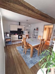 a kitchen and dining room with a table and chairs at Bel appartement indépendant centre de Magny-Cours avec parking in Magny-Cours