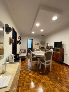 a kitchen and living room with a table and chairs at PRAÇA AL in São João da Madeira