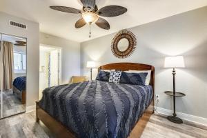 a bedroom with a bed and a ceiling fan at Emerald Beach #1227 by Book That Condo in Panama City Beach