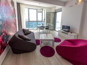 a living room with a couch and a table at Apart Hotel Sea Fort in Sutomore