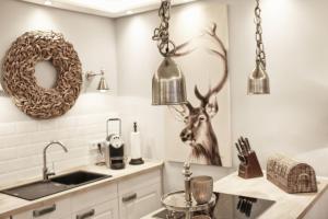 a kitchen with two hanging lights and a sink at HOME Suites Apartment 5 in Braunlage