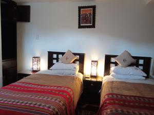 A bed or beds in a room at Cusco Bed and Breakfast