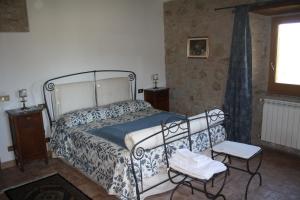 a bedroom with a bed and a table and a window at Agriturismo La Casaccina in Trevinano +36 photos