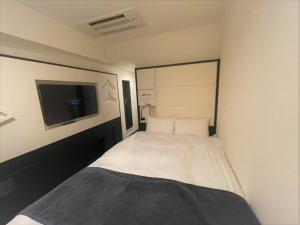 Postel nebo postele na pokoji v ubytování HOTEL SUI KANDA by ABEST