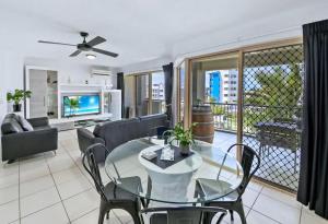 a living room filled with furniture and a large window at Paradis Pacifique in Maroochydore