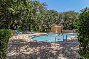 a swimming pool with chairs and a gazebo at 4954 Summer Beach Blvd in Fernandina Beach