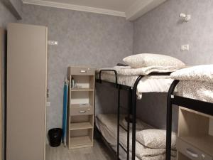 a room with two bunk beds and a mirror at Hostel "Гном & Gnome" in Lviv