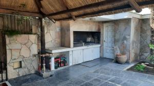 a patio with an outdoor kitchen with a stove at Casa Villa Nueva in Mendoza