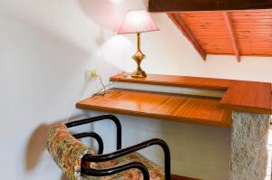 a chair sitting under a desk with a lamp at Tu Lugar in Colón