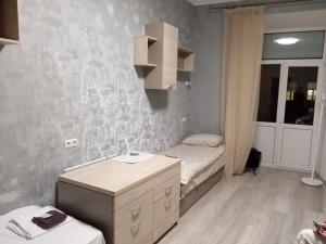 a small bedroom with a bed and a small cabinet at Hostel "Гном & Gnome" in Lviv