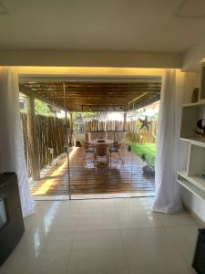 a view of a patio with a table on a deck at GUARAJUBA Condomínio PARAÍSO DOS CORAIS BEACH RESORT 132 in Guarajuba