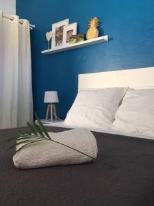 - une chambre dotée d'un lit avec un mur bleu dans l'établissement Eden Location, à Les Trois-Îlets