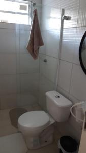 biała łazienka z toaletą i oknem w obiekcie Maria Farinha casa w mieście Maria Farinha