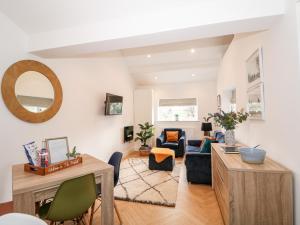 a living room with a couch and a table at The Pinfold in Melton Mowbray