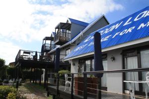 
a blue and white building with a blue roof at Lagoon Lodge in Knysna
