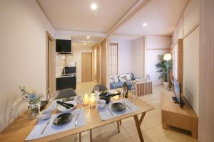a living room with a table and a living room at T-home in Tokyo