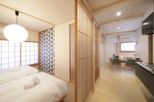 a hotel room with two beds and a kitchen at T-home in Tokyo