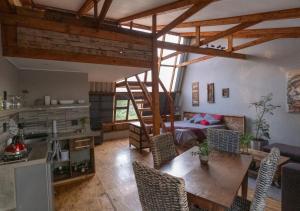 a living room with a table and a bed at Little Forest Farm in Magaliesburg