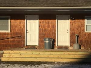 a porch with two white doors and a trash can at Home Away From Home, Recently Renovated in North Troy