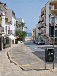 an empty street in a city with the ocean at Altea city center in Altea
