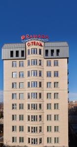 a building with a sign on top of it at Ramada by Wyndham Rostov-on-Don Hotel and Spa in Rostov on Don