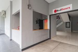 a hallway with a red door in a building at RedDoorz near Exit Toll Pasteur 4 in Bandung